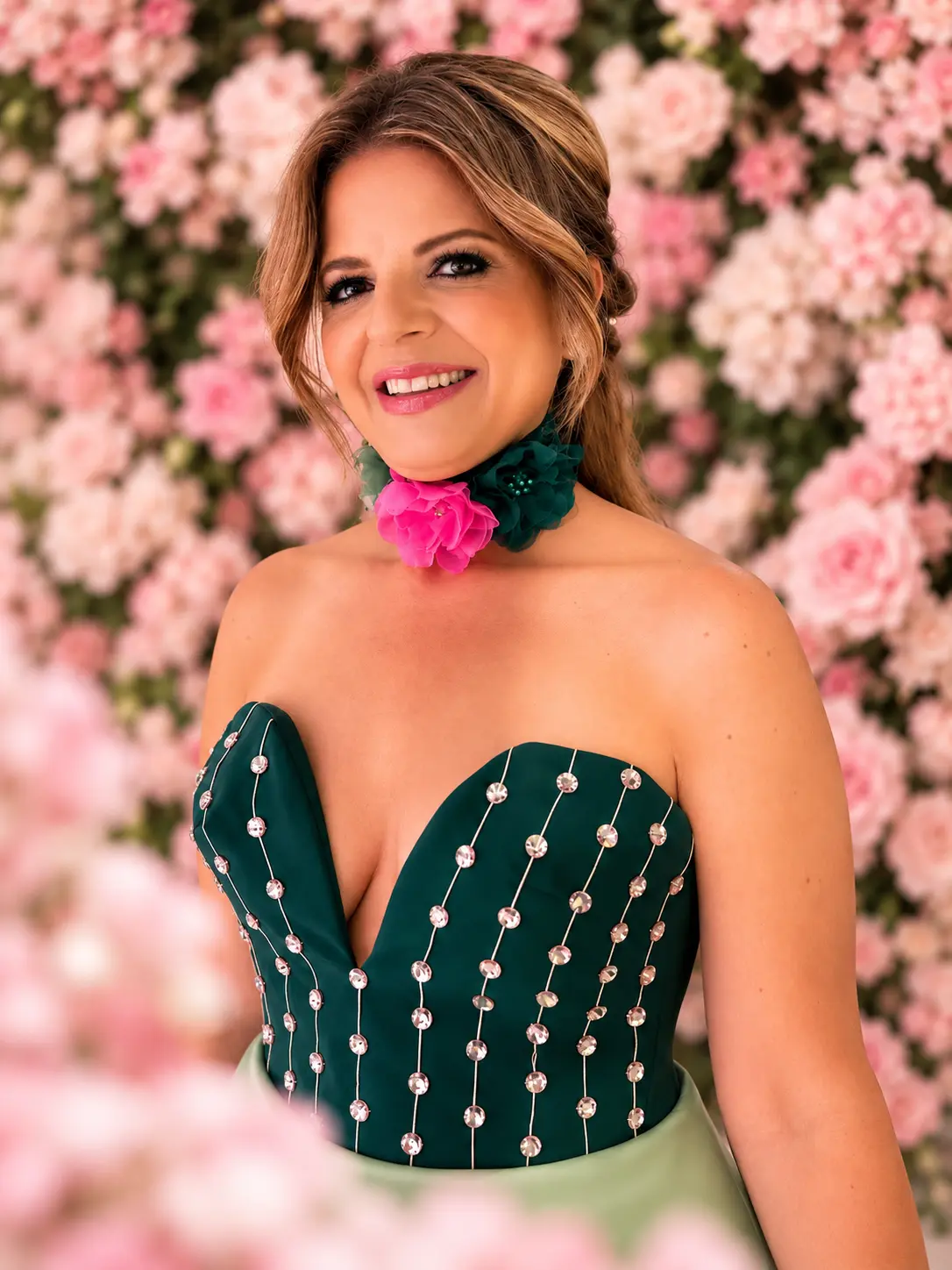 Sima Azadegan in front of a pink floral wall